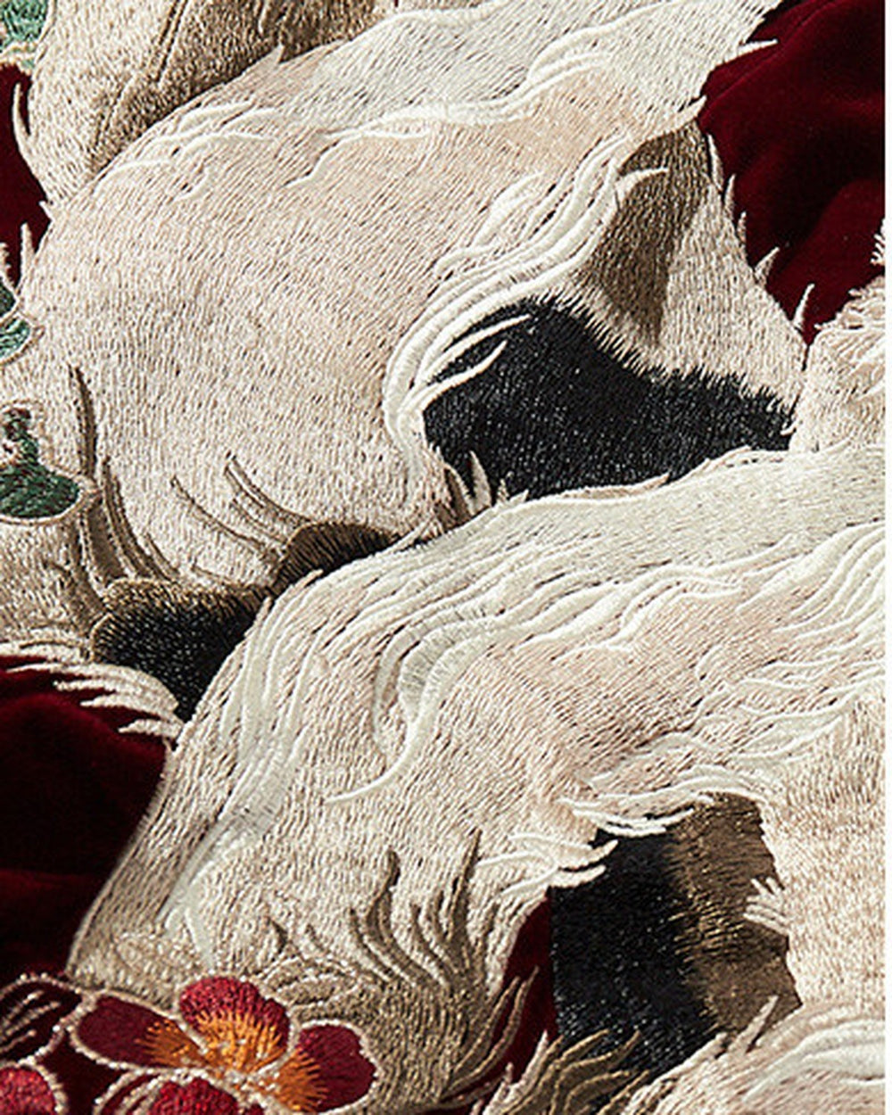 Close-up of the white fox tails and pink peony embroidery