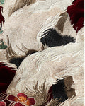 Close-up of the white fox tails and pink peony embroidery