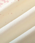 Close-up of the cream twill with small pink splatter specks
