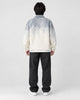 Model wearing the gray ombre shirt jacket, back view of the fade