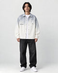 Model wearing the gray ombre shirt jacket open over a white tee, front view