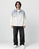 Model wearing the gray ombre shirt jacket open over a white tee, front view