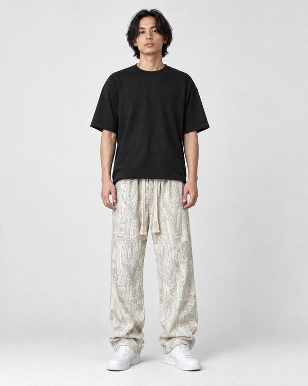 Model wearing the cream outline letter corduroy pants, front view