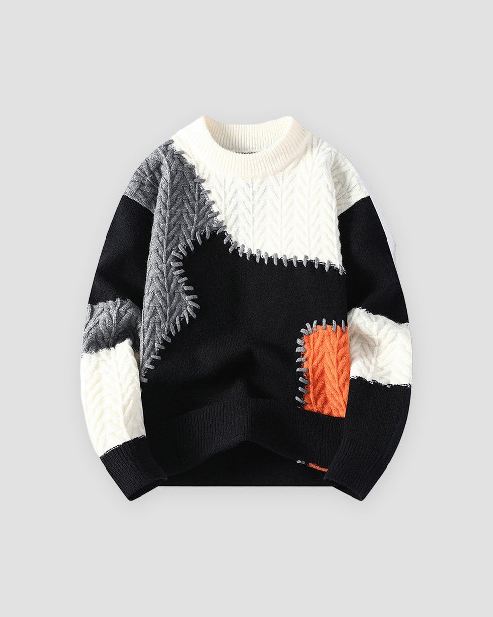 Black patchwork cable knit sweater, front view, black, gray and orange patches on cream
