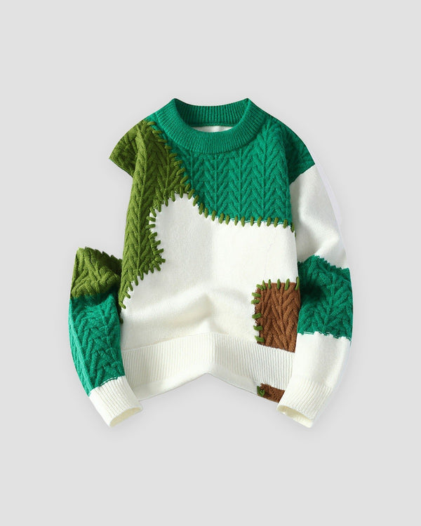 Green patchwork cable knit sweater, front view, cream base with green and brown patches