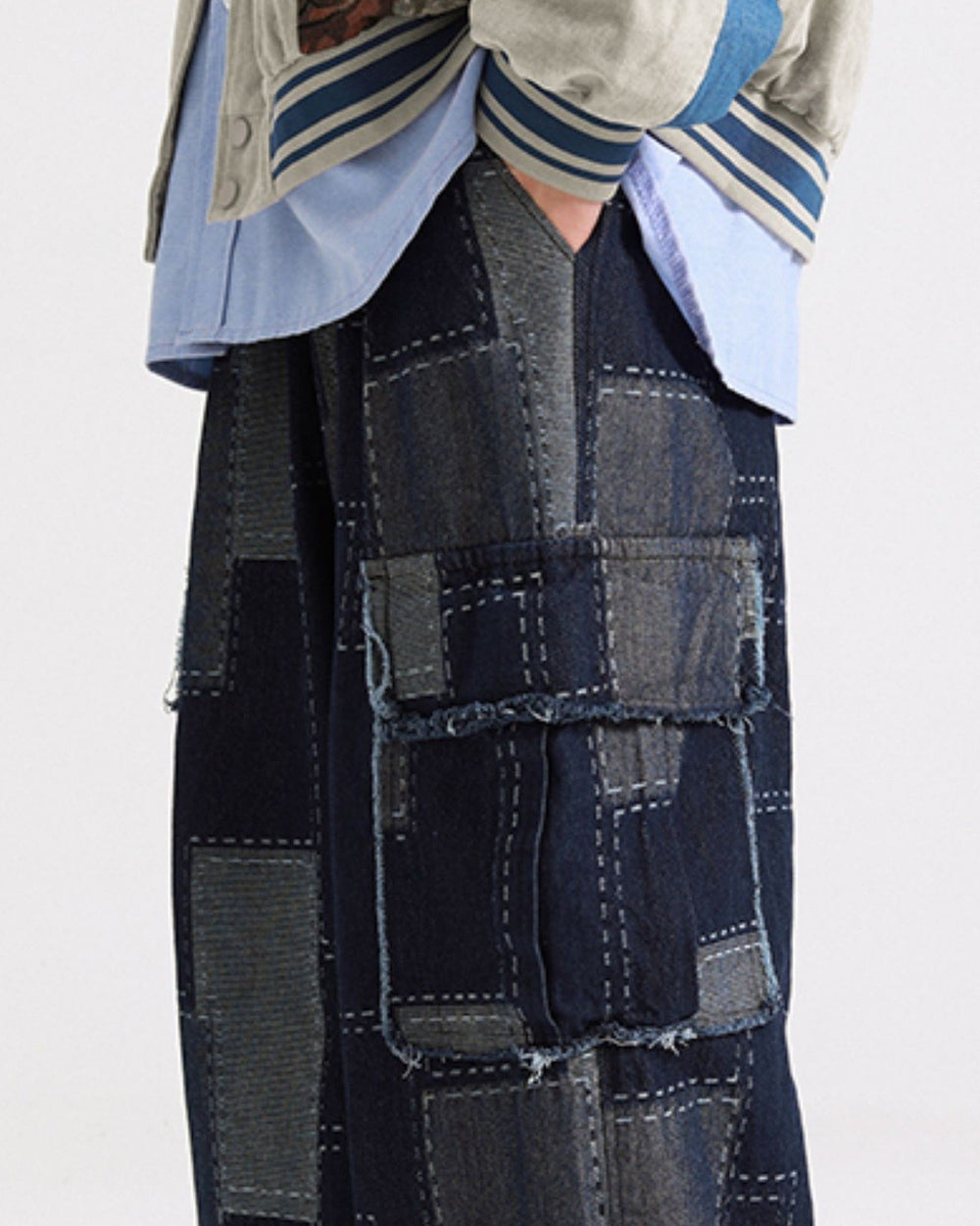 Side view of the indigo patchwork cargo pants with the wide straight leg and flap pocket