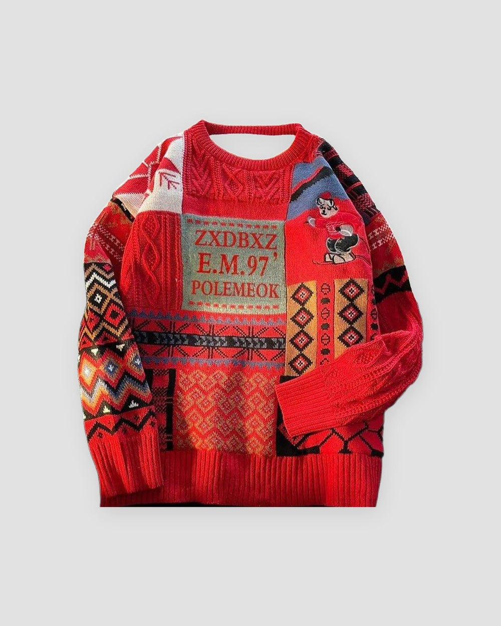 Red patchwork knit sweater with snowflake and diamond bands and a lettered patch, front view