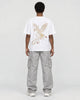 Model wearing the white phoenix embroidered T-shirt, back view
