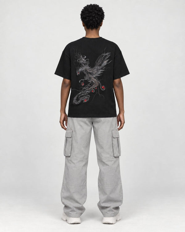 Woman seen from behind in the black phoenix tee, the phoenix filling the back
