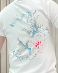 Close-up of the pale blue phoenixes and pink lotus printed on the back of the white tee