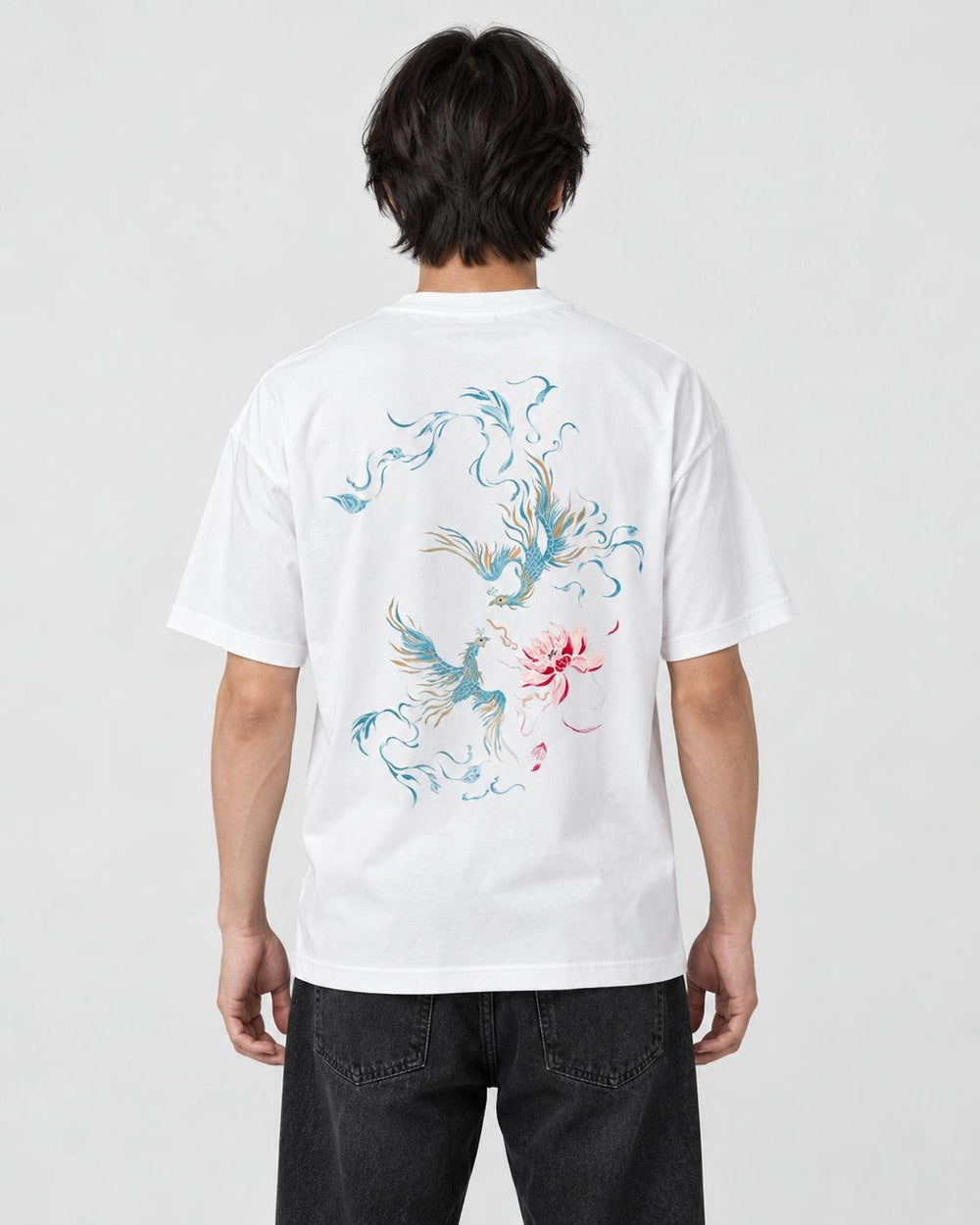 Model wearing the white phoenix and lotus print T-shirt with black jeans, back view