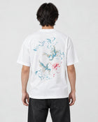 Model wearing the white phoenix and lotus print T-shirt with black jeans, back view