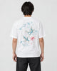 Model wearing the white phoenix and lotus print T-shirt with black jeans, back view