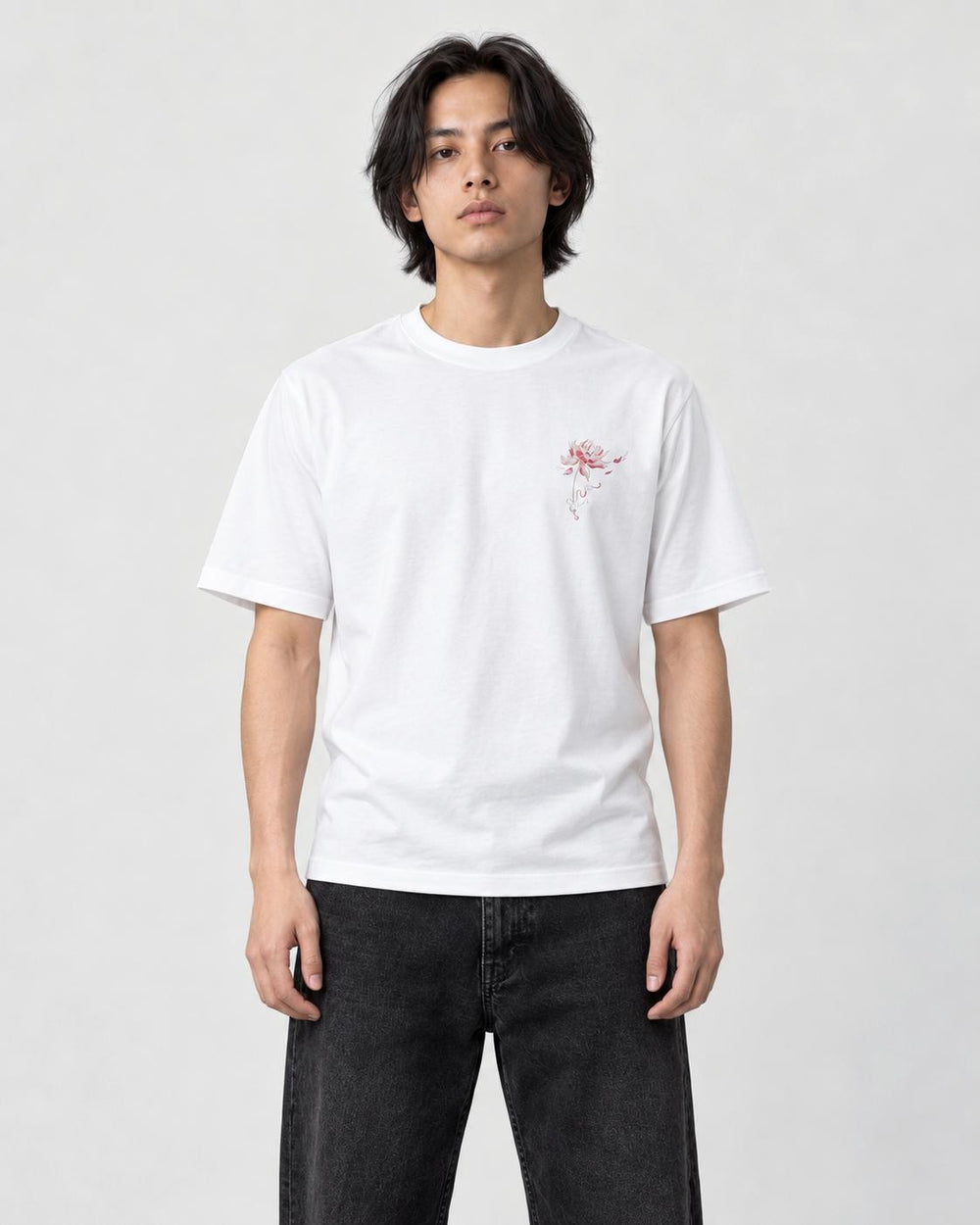 Model wearing the white T-shirt with a small pink lotus on the left chest, front view