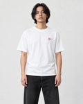 Model wearing the white T-shirt with a small pink lotus on the left chest, front view