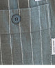 Close-up of the buttoned back pocket and label on the gray pinstripe