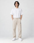 Model wearing the beige pinstripe drawstring pants, front view