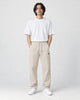 Model wearing the beige pinstripe drawstring pants, front view