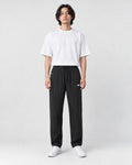 Model wearing the black pinstripe drawstring pants, front view