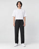 Model wearing the black pinstripe drawstring pants, front view