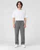 Model wearing the gray pinstripe drawstring pants with a white tee, front view