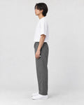 Model wearing the gray pinstripe drawstring pants, side view