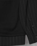 Close-up of the buttoned pinstripe cuff and striped hem band