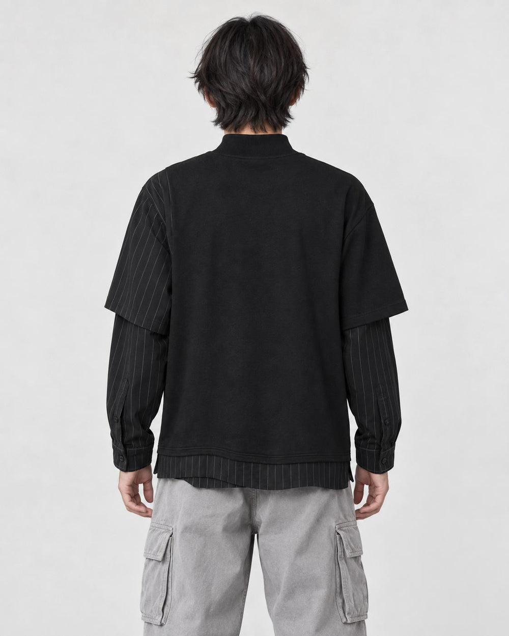 Model wearing the pinstripe layered sweatshirt, back view