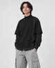 Model wearing the layered mock neck sweatshirt with light gray cargo trousers, three-quarter view