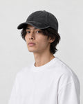Man wearing the plain black washed cotton baseball cap, three-quarter view