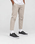 Model wearing the black platform sneakers with stone pants and white socks, from the hips down