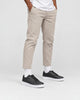 Model wearing the black platform sneakers with stone pants and white socks, from the hips down