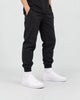 Model wearing the white platform sneakers with slim black pants and white socks, from the hips down