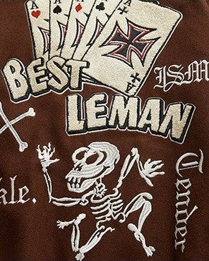 Close-up of the embroidered playing cards, BEST LEMAN lettering and skeleton on the back
