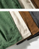 Close-up of the wide-wale corduroy in green, cream, brown, gray and black