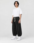 Model wearing the black corduroy wide-leg pants, three-quarter view