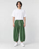 Model wearing the green corduroy wide-leg pants with a white tee, front view