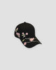 Black baseball cap with a pink plum blossom branch embroidered across the brim