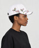 Model wearing the white plum blossom cap, side view of the embroidered branch