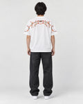 Model wearing the white plum blossom T-shirt, back view of the embroidery