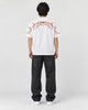 Model wearing the white plum blossom T-shirt, back view of the embroidery