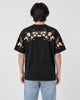 Model wearing the black plum blossom T-shirt, back view of the embroidered garland