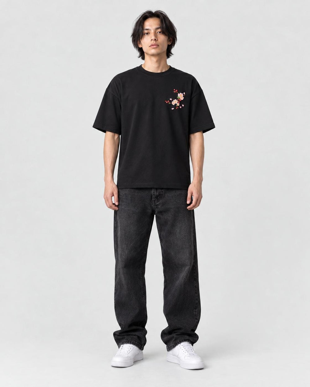 Model wearing the black plum blossom T-shirt, front view
