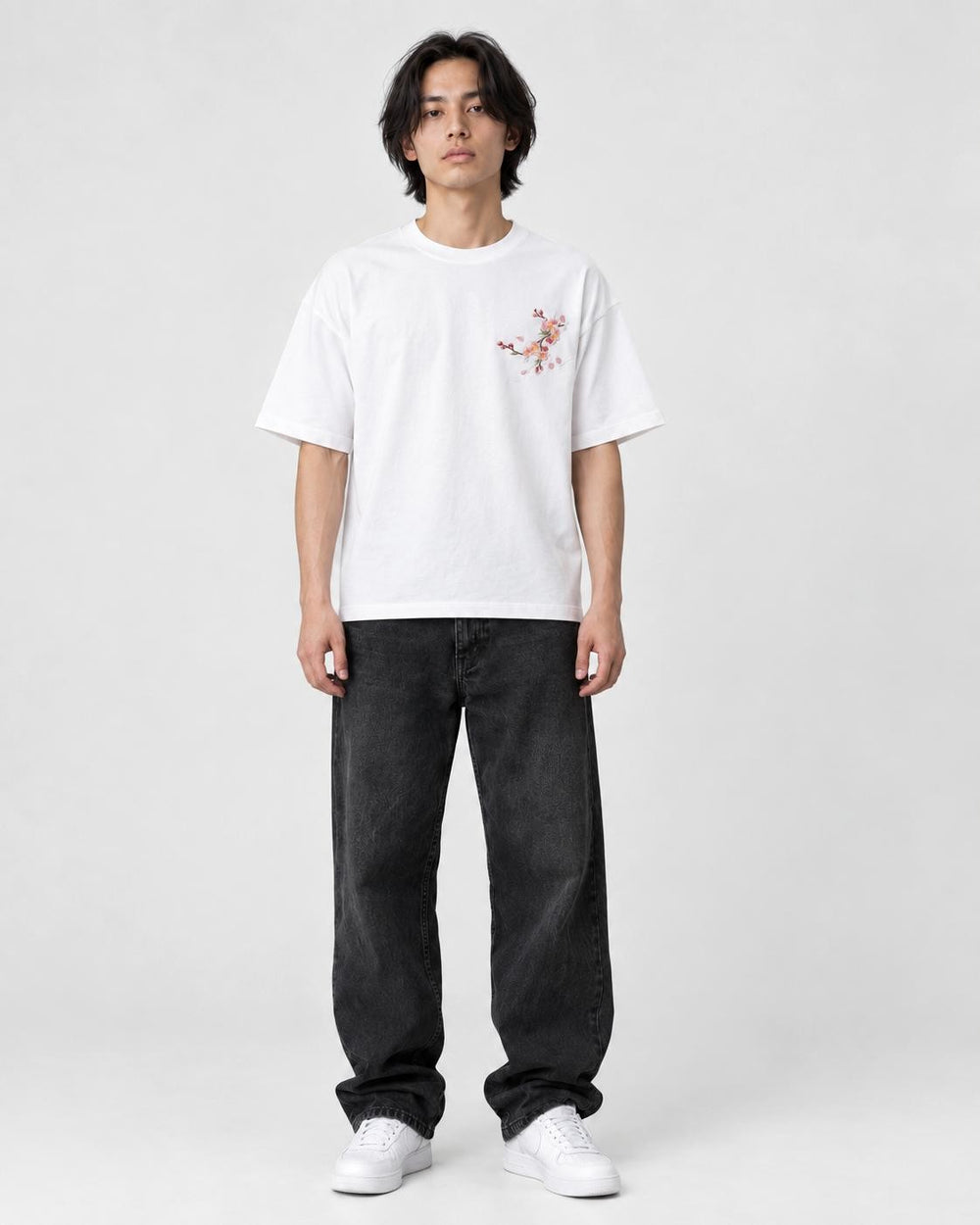 Model wearing the white plum blossom T-shirt, front view with the chest sprig