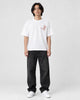 Model wearing the white plum blossom T-shirt, front view with the chest sprig