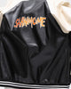 Close-up of the orange lettering across the back of the baseball jacket