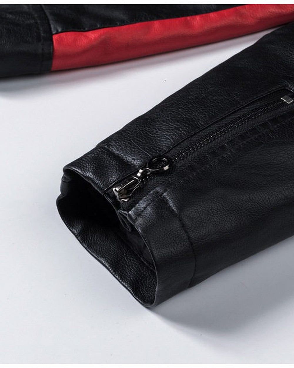 Close-up of the zipped cuff on the black jacket
