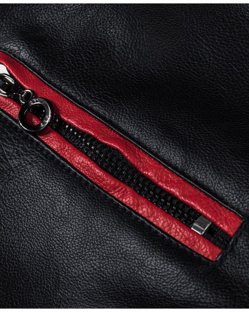 Close-up of a zip chest pocket with red piping