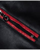 Close-up of a zip chest pocket with red piping