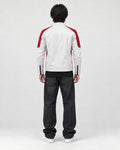 Model wearing the white and red moto jacket, back view